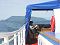 Relaxing at the stern deck while crossing the lake to the Holy Nose peninsula