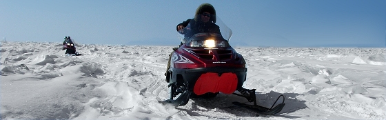 Travel on a snowmobile across lake Baikal