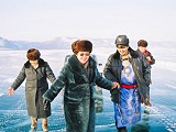 Tour to Baikal - Tour to Olkhon: Crossing the strait to Olkhon. A stop is done to take a glance through the ice. People are amazed.